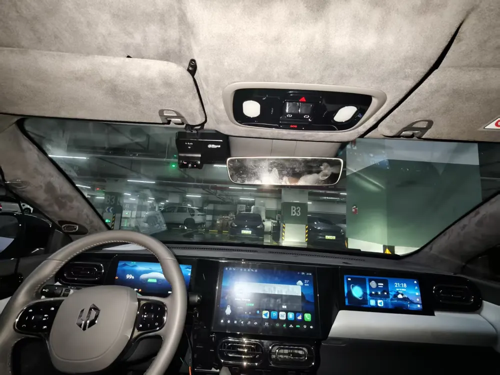 Dashcam instalada en el parabrisas de un automóvil, junto al espejo retrovisor